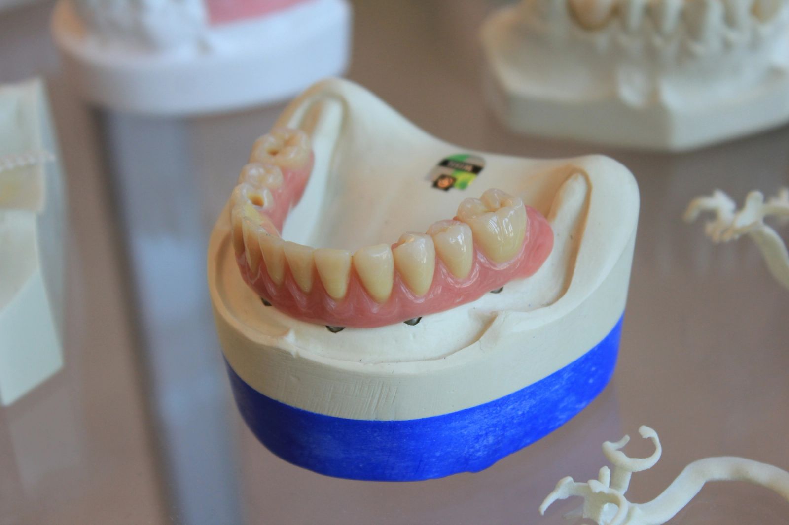 a woman is sitting in a dental chair while a dentist examines her teeth .